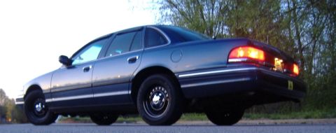 1996 Ford Crown Victoria - Rear quarter view of a dark blue 1996 Ford Crown Victoria sedan parked on asphalt.
