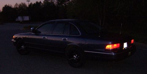 1996 Ford Crown Victoria - Rear view of a 1996 Ford Crown Victoria sedan parked outdoors during twilight.