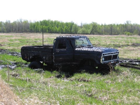 1977 Ford F-150 - A 1977 Ford F-150 is stuck in the mud after an off-road event.