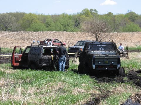 1977 Ford F-150 - Multiple off-road vehicles are stuck in the mud during an event.