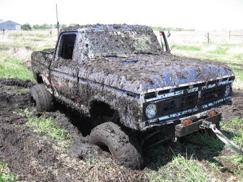 1977 Ford F-150 - This 1977 Ford F-150 is deeply stuck in mud, with its front end partially submerged.