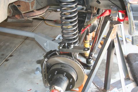1992 Ford Bronco - Close-up view of a vehicle's front suspension system, showing modified components.
