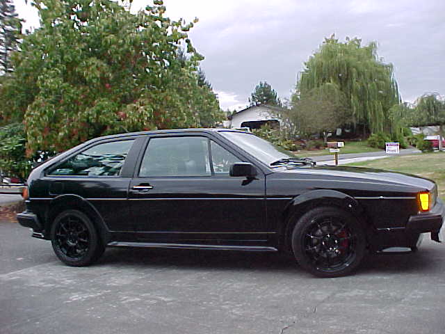 Black 1987 Volkswagen Scirocco parked on a driveway, side view