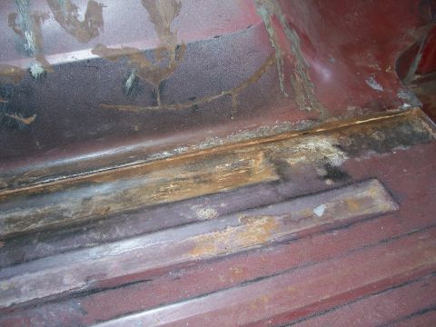 1978 Ford Bronco - The interior floor shows significant rust and wear, with visible seams and support beams.