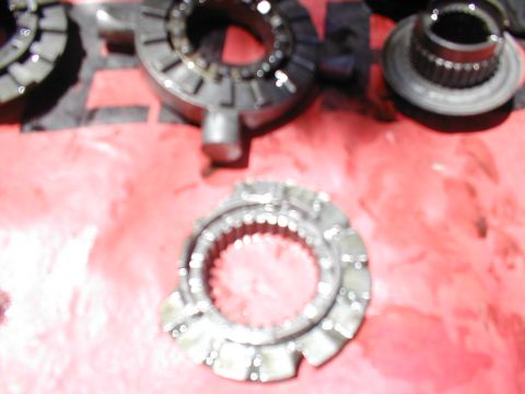1979 Ford Bronco - Close-up of a transmission clutch pack, showing multiple splined rings laid out on a red surface.