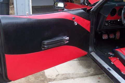 1972 Ford Ranchero - Custom interior of a 1972 Ford Ranchero, red and black door panels and racing seats.