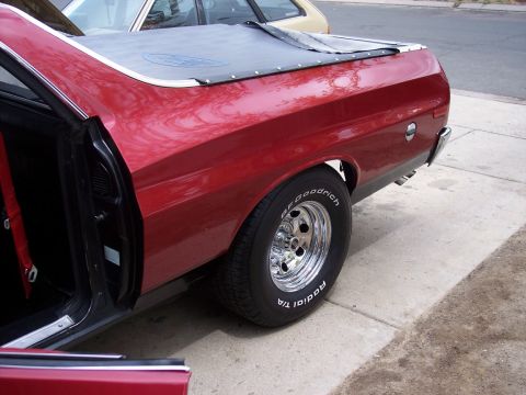 1972 Ford Ranchero - Side view of a 1972 Ford Ranchero with a red finish and a black tonneau cover.