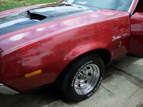 1972 Ford Ranchero - Close-up of the front fender and hood scoop on a red 1972 Ford Ranchero 500.