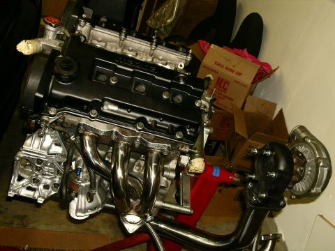 1995 Ford Probe - A Mazda engine, likely for a performance build, is shown with a turbocharger and exhaust manifold.