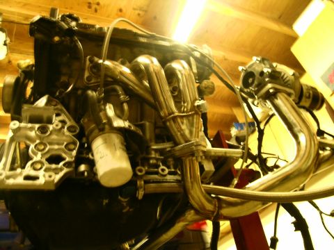 1995 Ford Probe - Close-up of an engine showing a custom exhaust manifold and oil filter.