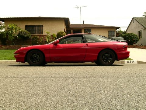 1993 Ford Probe - This red 1993 Ford Probe is captured in a side profile, its coupe body style.