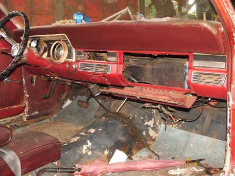 1966 Ford Ranchero - The interior dashboard of a 1966 Ford Ranchero shows signs of wear and tear, with exposed wiring and missing components.