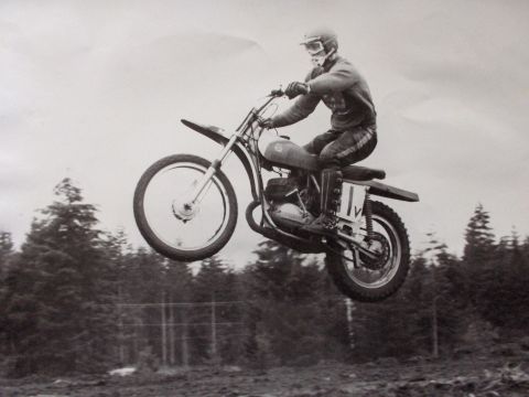 1968 Ford Ranchero - A rider soars through the air on a dirt bike, with a forest in the background.