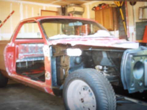 1968 Ford Ranchero - This vehicle is in a state of disrepair, with its doors removed and the front end partially disassembled.