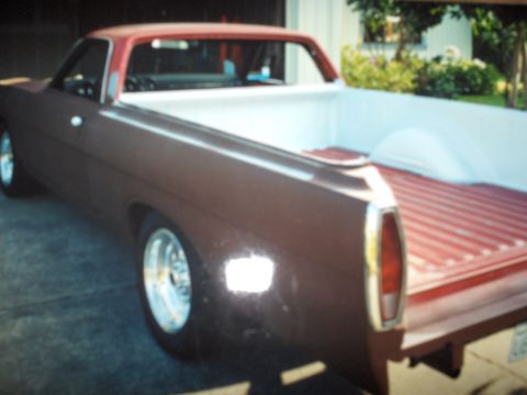 1968 Ford Ranchero - This 1968 Ford Ranchero pickup truck features a brown body with a red roof and bed.