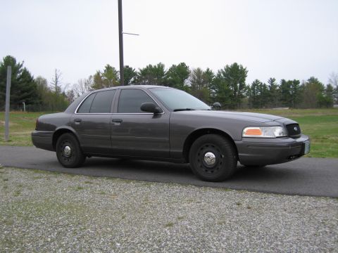 1991 Ford LTD Crown Victoria - This sedan, likely a Ford Crown Victoria, is viewed from the front three-quarter angle.