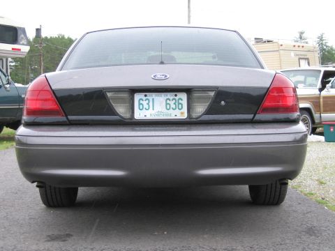 1991 Ford LTD Crown Victoria - Rear view of a gray Ford Crown Victoria with a dark trim panel and New Hampshire license plate.