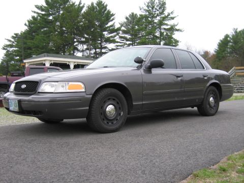 1991 Ford LTD Crown Victoria - This gray sedan is viewed from the front quarter, showing its license plate.