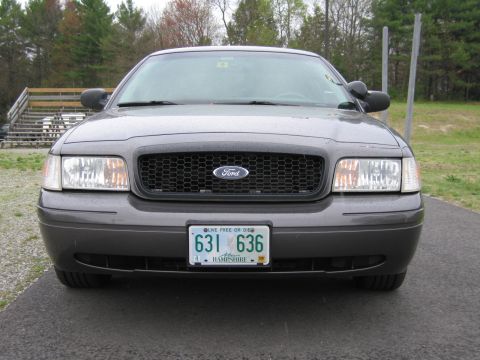 1991 Ford LTD Crown Victoria - Gray Ford Crown Victoria parked outdoors, showing its front grille and headlights.