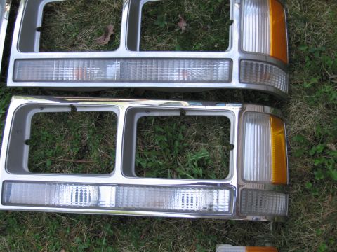 1991 Ford LTD Crown Victoria - Pair of car headlight assemblies, likely for a Ford truck or SUV, shown outdoors.