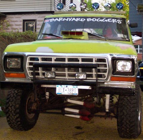 1978 Ford Bronco - This modified pickup truck features a prominent snorkel and multiple auxiliary lights mounted on the roof.