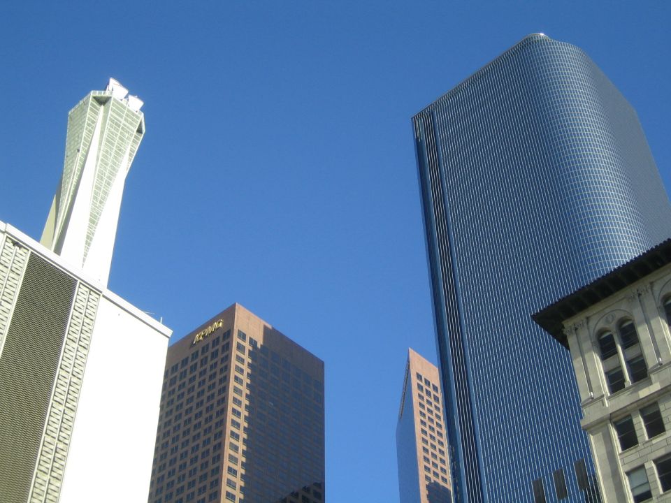City skyline with tall modern buildings against a clear blue sky