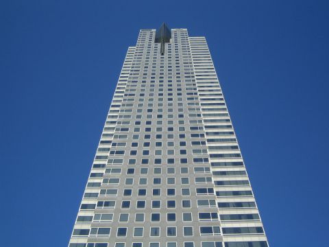 1968 Ford Mustang - A tall building with many windows stretches towards the sky.