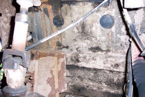 1978 Ford Bronco - Undercarriage view showing frame rust and suspension components.