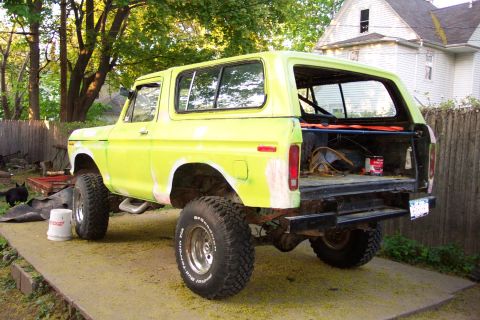 1978 Ford Bronco - The rear of a lifted Ford Bronco shows its open tailgate with tools and supplies inside.