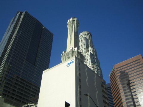 1968 Ford Mustang - A view of several tall buildings in a city, set against a bright blue sky.