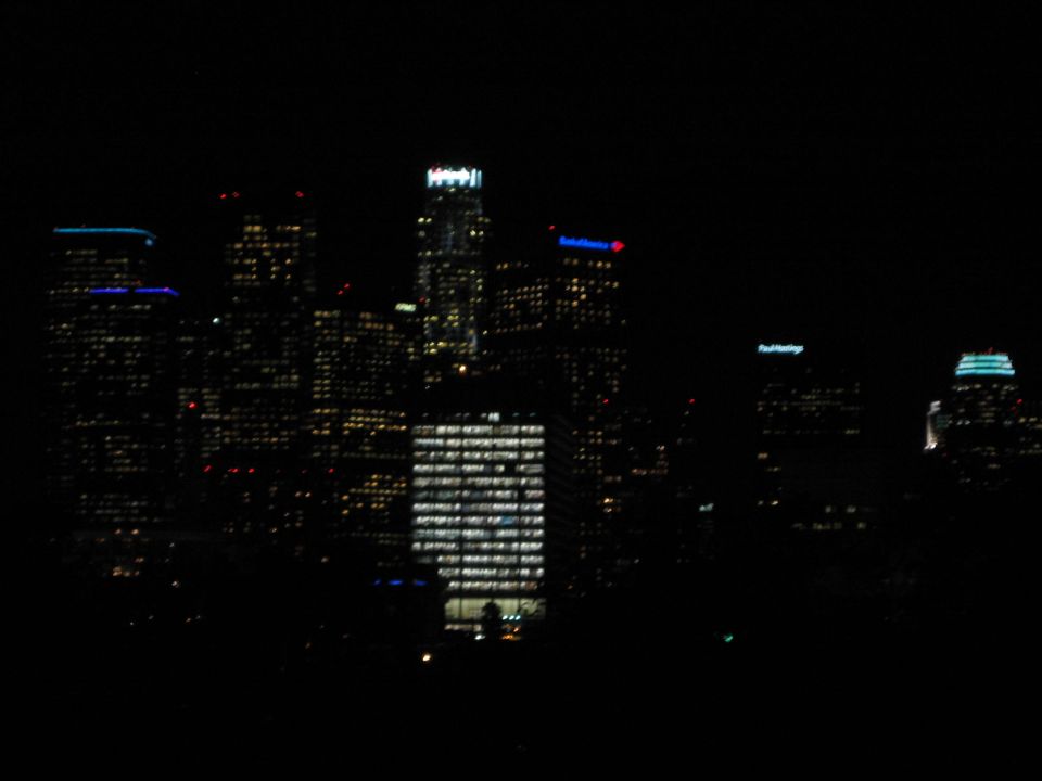 City skyline at night with many illuminated buildings