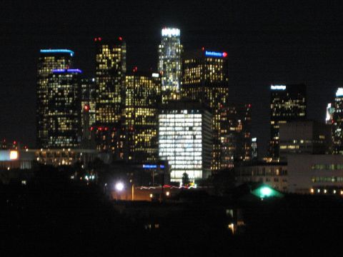 1968 Ford Mustang - Night view of a city skyline with lights on in numerous skyscrapers.