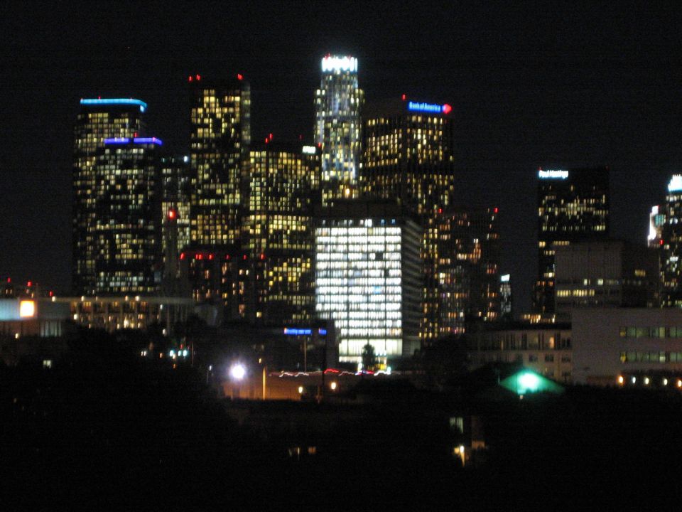 City skyline at night with many illuminated buildings