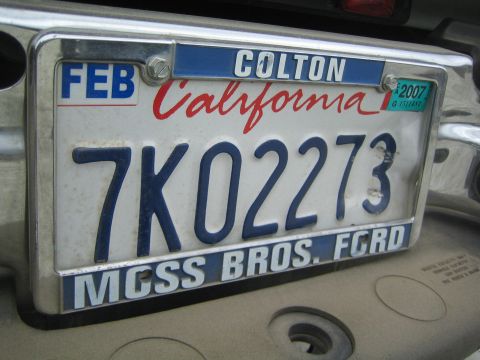 1990 Ford Bronco - Close-up of a California license plate reading 7KO2273 in a Moss Bros. Ford Colton frame with a 2007 registration sticker.