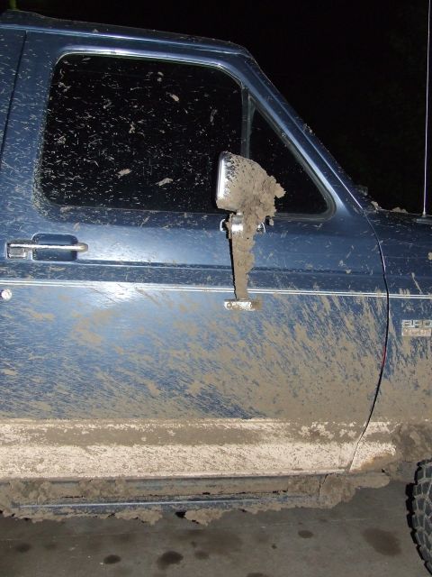 1986 Ford Bronco - Mud covers the side of a blue 1986 Ford Bronco after off-roading.