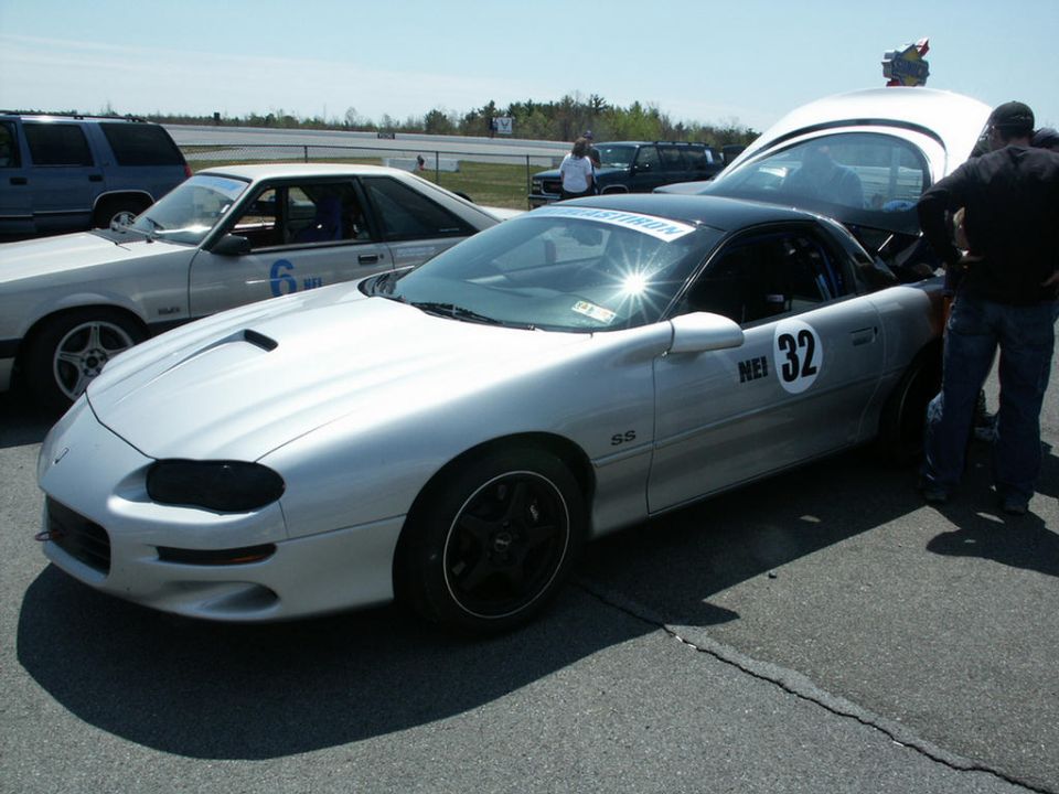 Silver Chevrolet Camaro SS with black top and racing numbers on the side