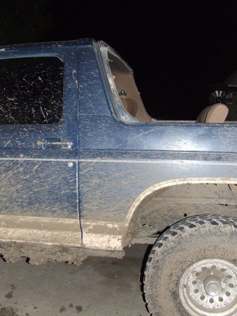 1986 Ford Bronco - This 1986 Ford Bronco is heavily covered in mud, obscuring much of its body.