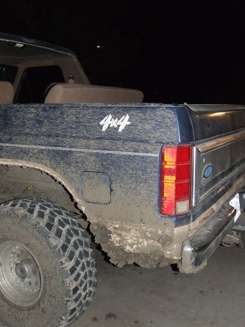 1986 Ford Bronco - This 1986 Ford Bronco is heavily coated in mud, with its 4x4 decal visible on the rear quarter panel.