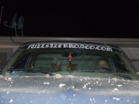 1986 Ford Bronco - Windshield view of a Ford Bronco with a prominent website sticker on the glass.