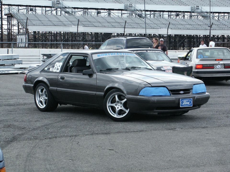 Dark gray Ford Mustang hatchback with racing number 89 and "NORTHEASTERN" banner