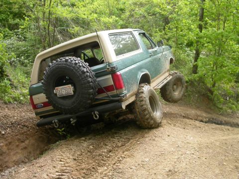 1990 Ford Bronco - This 1990 Ford Bronco navigates a steep, muddy incline on a wooded trail.