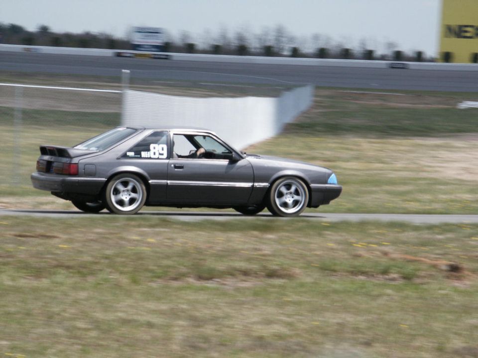 Gray coupe with racing number 89 on door, side view
