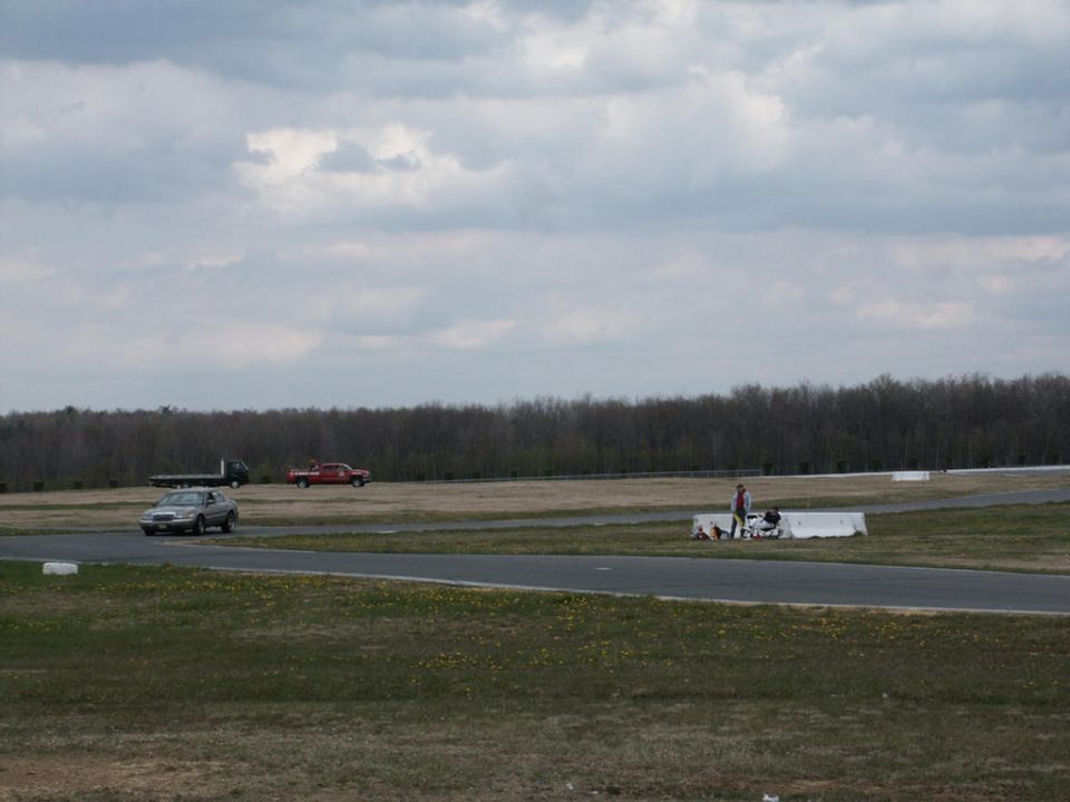 Silver sedan on a racetrack, viewed from the front-right