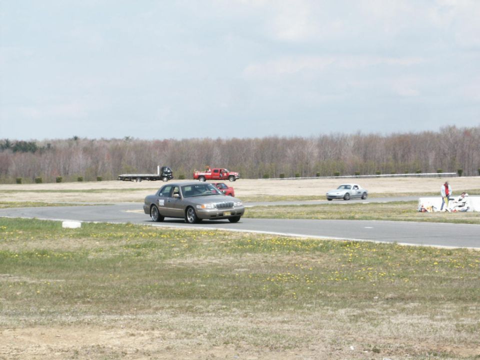 Gray 2001 Mercury Grand Marquis on race track with other cars
