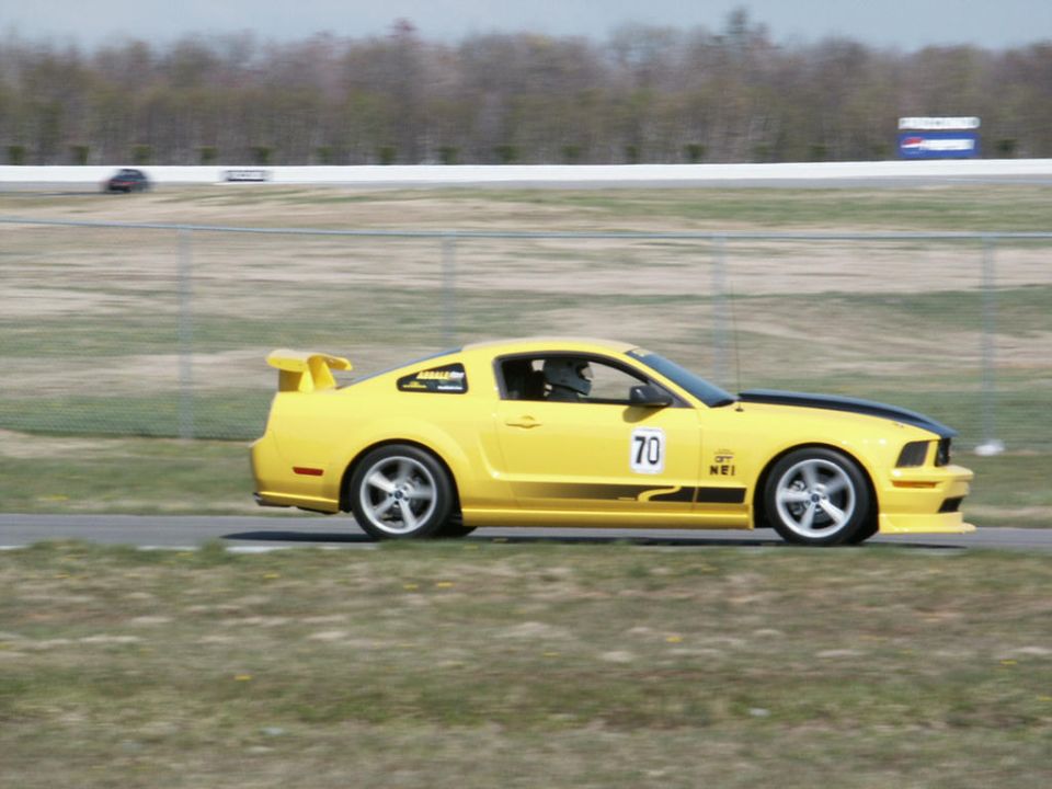 Yellow 2005 Ford Mustang GT on track