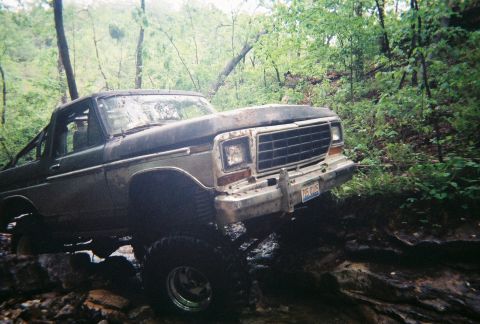 1978 Ford Bronco - This 1978 Ford Bronco is shown off-roading through a wooded, rocky area.