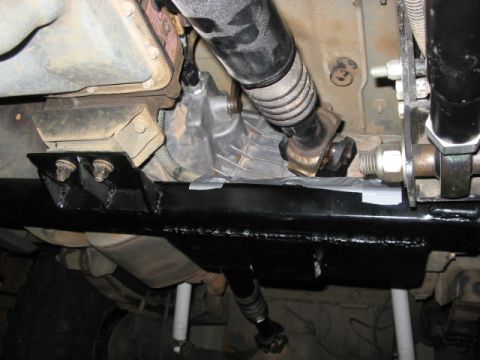 1995 Ford Bronco - Underside view of a vehicle's transfer case and driveshaft assembly, with visible modifications.