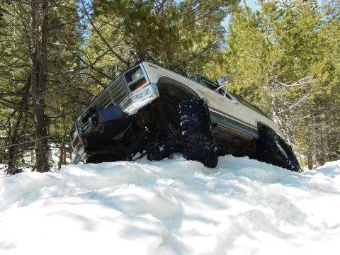 1986 Ford Bronco - This 1986 Ford Bronco navigates a snowy terrain, its off-road capabilities with large tires.