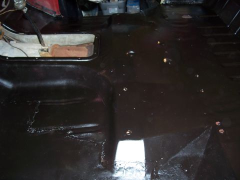 1978 Ford Bronco - The interior floor pan of a vehicle appears to have been recently coated or painted.