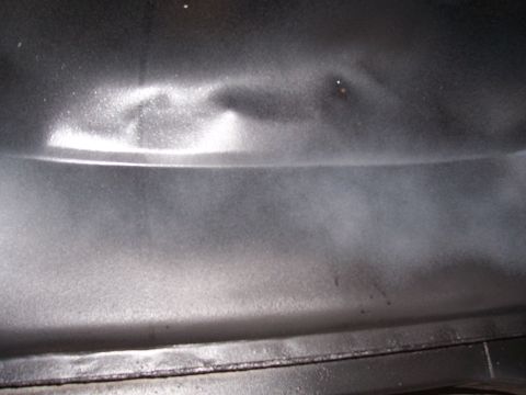 1978 Ford Bronco - Close-up of a dented metal panel, showing damage and a horizontal crease.